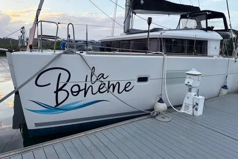 Slide: The Image of 2018 Lagoon 400 S2 catamaran docked, featuring "La Bohème" on the hull. - 39