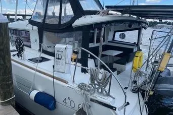 Slide: The Image of 2018 Lagoon 400 S2 catamaran docked, featuring spacious deck and modern design. - 8