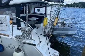 Slide: The Image of 2018 Lagoon 400 S2 catamaran docked with dinghy and nautical equipment. - 9
