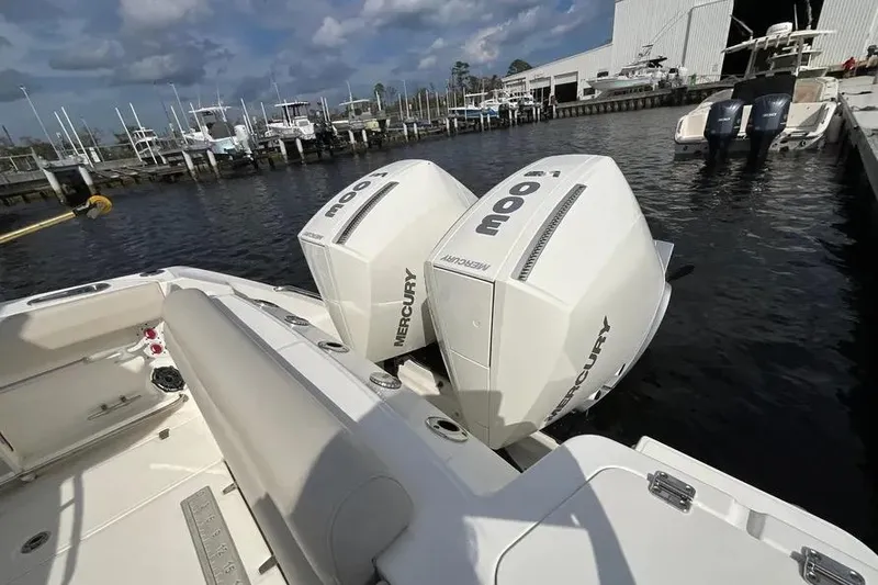 Slide: The Image of 2024 Boston Whaler 280 Outrage with twin Mercury engines docked at marina. - 12