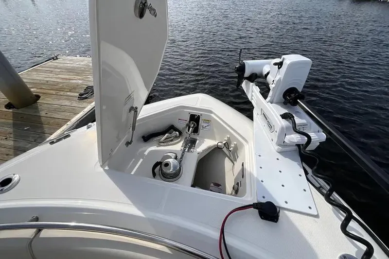 Slide: The Image of 2024 Boston Whaler 280 Outrage boat with open anchor compartment and trolling motor. - 15