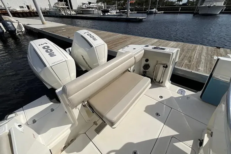 Slide: The Image of 2024 Boston Whaler 280 Outrage boat with dual outboard engines at dock. - 3