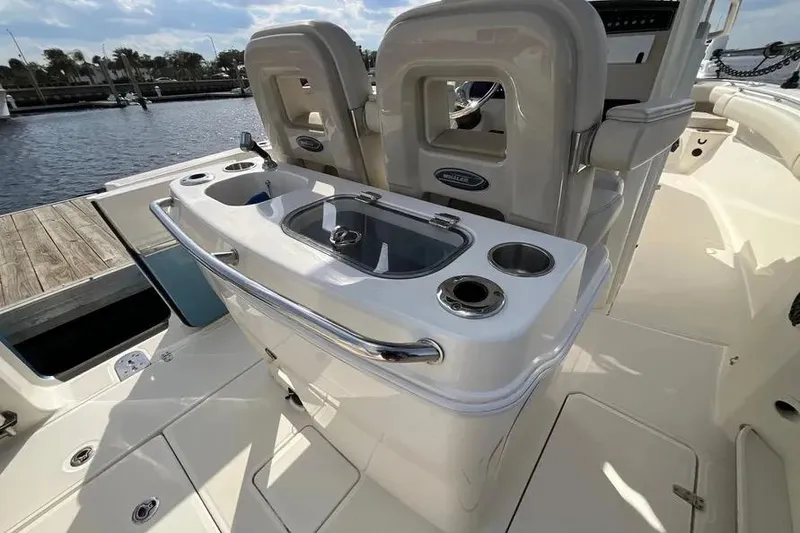 Slide: The Image of 2024 Boston Whaler 280 Outrage boat interior with seating and console features. - 4