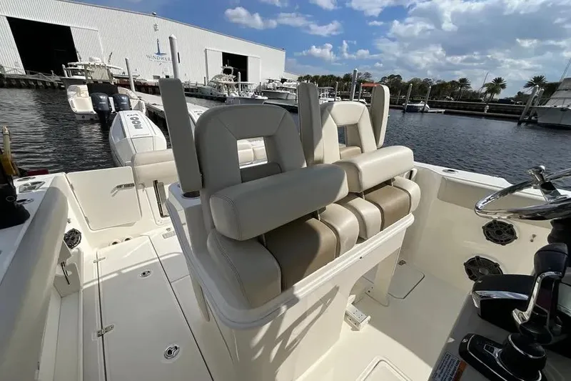 Slide: The Image of 2024 Boston Whaler 280 Outrage boat interior with seating and steering wheel. - 9