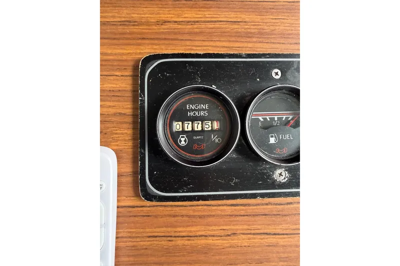 Slide: The Image of Close-up of 1987 Jamestowner 14x60 engine hours and fuel gauge on wood panel. - 10