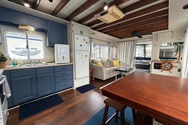 Slide: The Image of Interior of a 1987 Jamestowner houseboat with modern kitchen and cozy living area. - 13