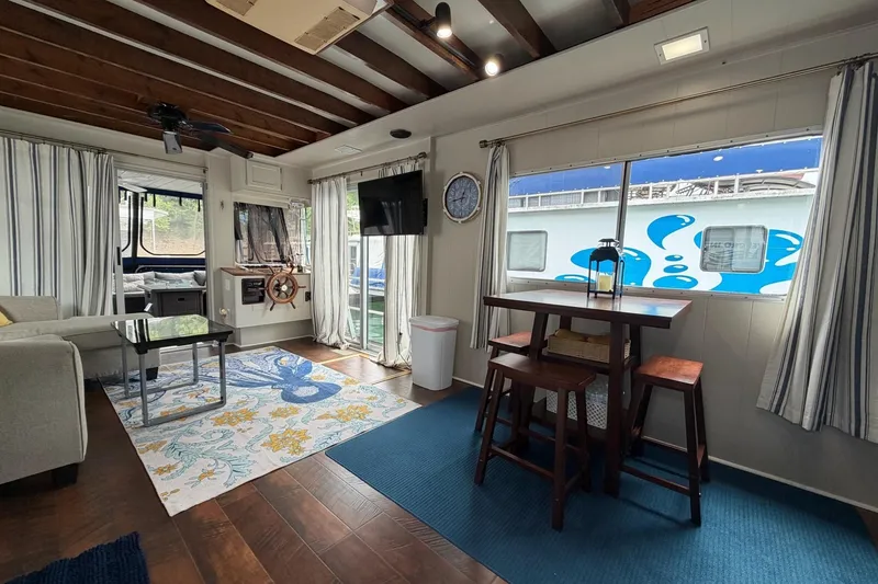 Slide: The Image of Interior of a 1987 Jamestowner 14x60 houseboat with modern decor and nautical accents. - 14