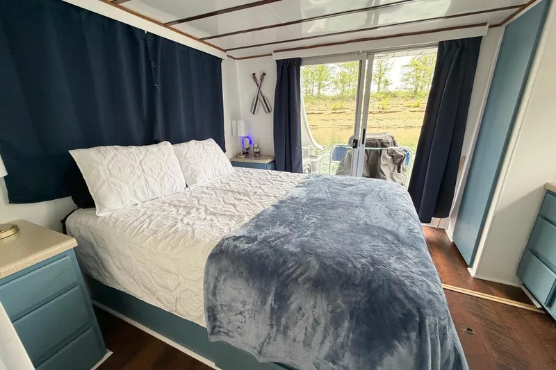 Slide: The Image of Cozy bedroom in a 1987 Jamestowner houseboat with elegant decor and natural light. - 18