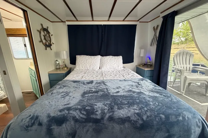 Slide: The Image of Cozy bedroom in 1987 Jamestowner houseboat with nautical decor and outdoor seating. - 20
