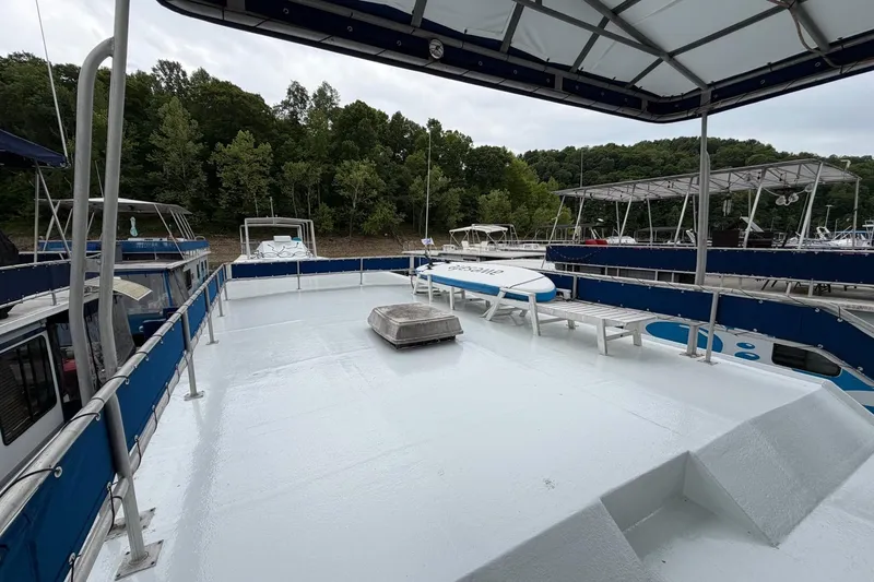 Slide: The Image of Upper deck of a 1987 Jamestowner 14x60 houseboat, featuring a spacious layout and scenic marina view. - 24