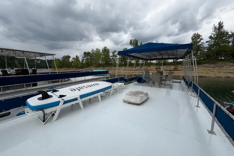Slide: The Image of Rooftop deck of 1987 Jamestowner 14x60 houseboat with paddleboard and seating area. - 26