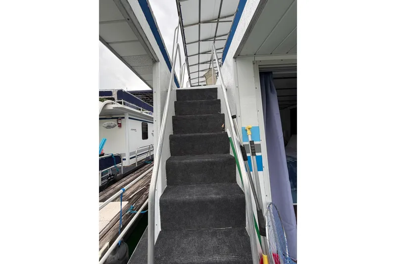 Slide: The Image of Staircase on a 1987 Jamestowner 14x60 houseboat leading to the upper deck. - 31