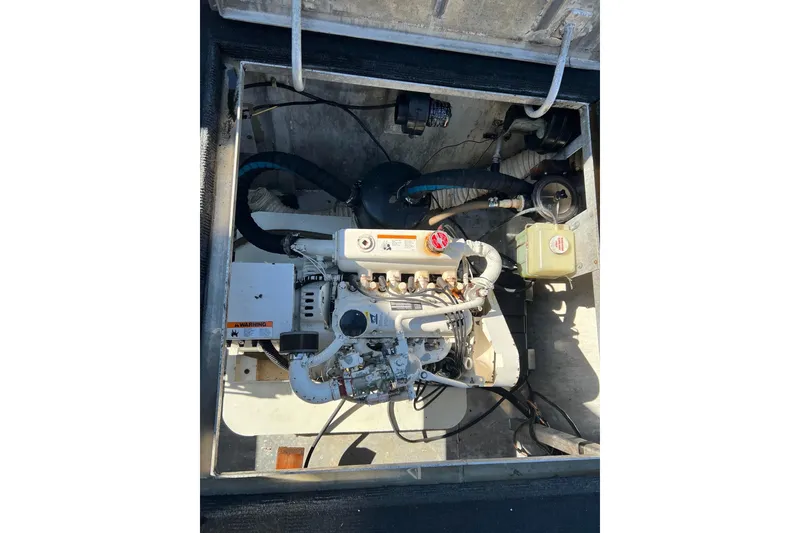 Slide: The Image of Engine compartment of a 1987 Jamestowner 14x60 houseboat, showing mechanical components. - 34