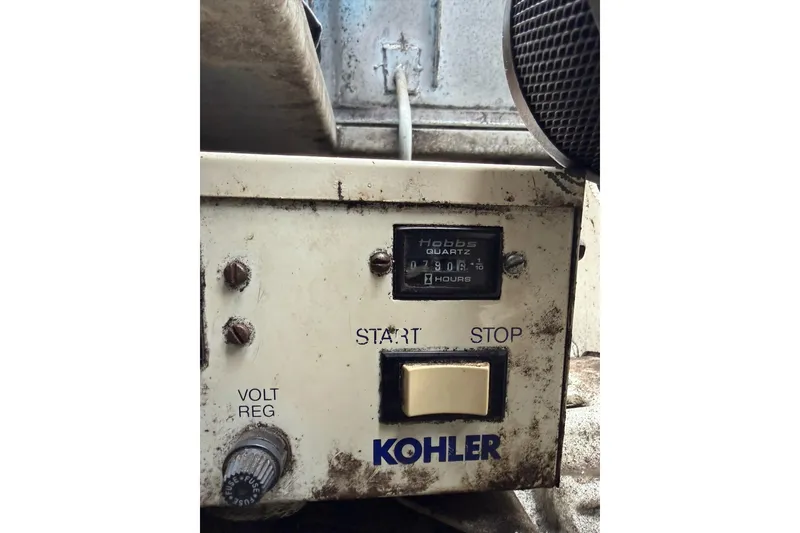 Slide: The Image of Control panel of a Kohler generator with hour meter and start/stop buttons. - 35