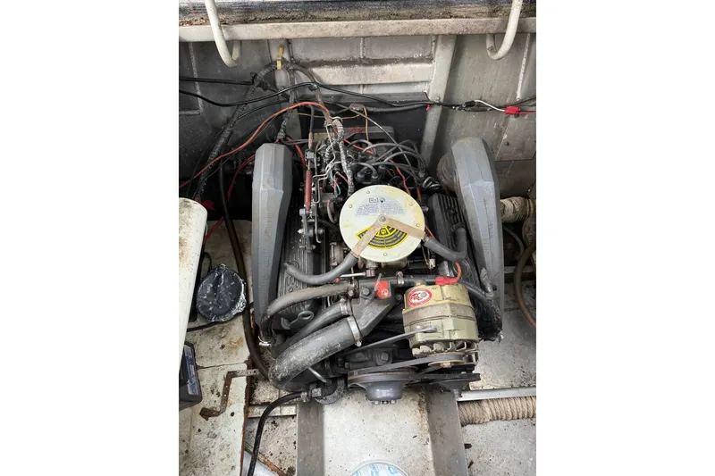 Slide: The Image of Engine compartment of a 1987 Jamestowner 14x60 houseboat, showing detailed mechanical components. - 36