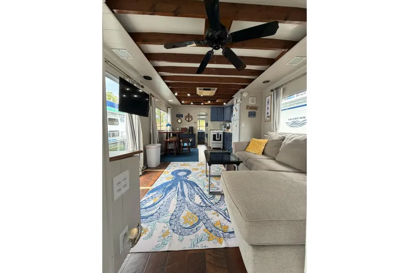 Slide: The Image of Interior of a 1987 Jamestowner 14x60 houseboat with cozy seating and nautical decor. - 6