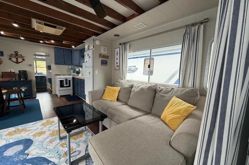 Slide: The Image of Cozy 1987 Jamestowner 14x60 houseboat interior with modern decor and comfortable seating. - 7