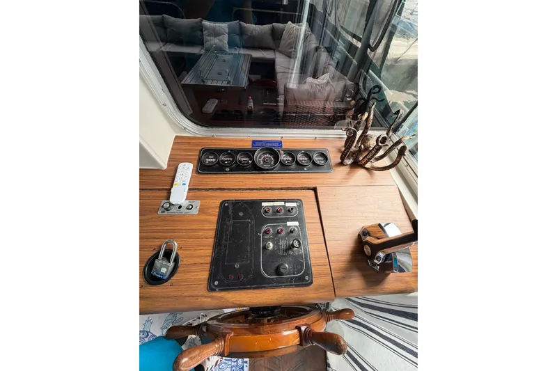 Slide: The Image of Control panel of a 1987 Jamestowner 14x60 houseboat with gauges and steering wheel. - 9