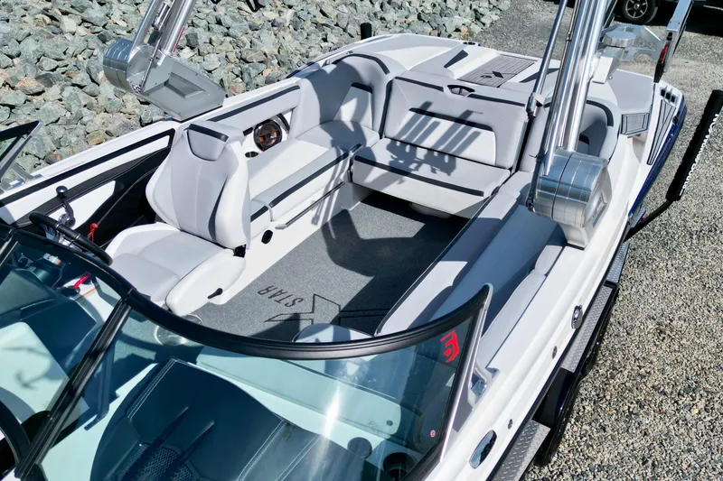 Slide: The Image of 2022 MasterCraft XStar boat interior with sleek seating and modern design. - 11