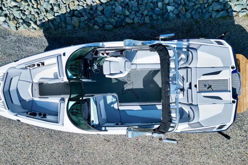 Slide: The Image of Overhead view of 2022 MasterCraft XStar boat on rocky shore. - 13