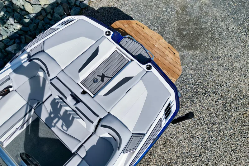 Slide: The Image of 2022 MasterCraft XStar boat interior with sleek seating and modern design. - 14
