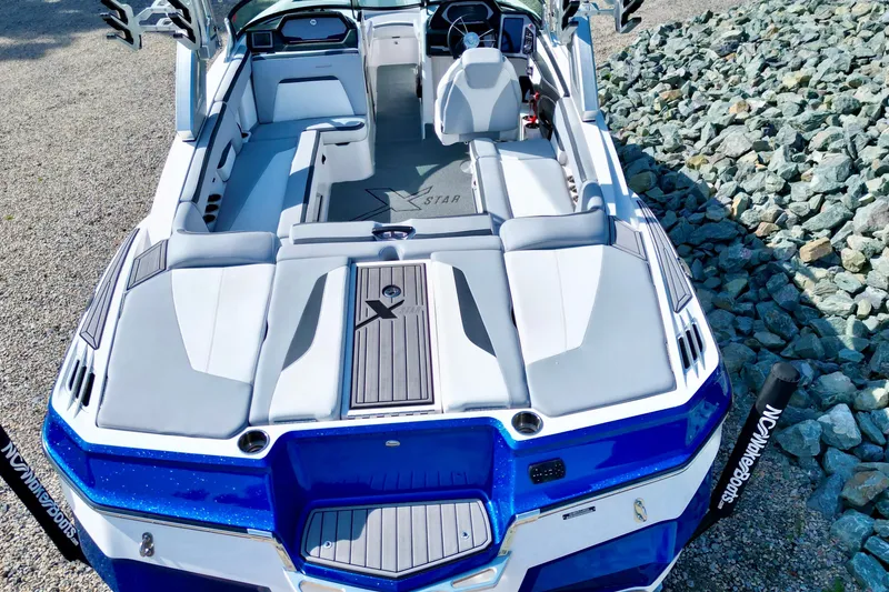 Slide: The Image of 2022 MasterCraft XStar boat interior with sleek seating and modern design. - 5