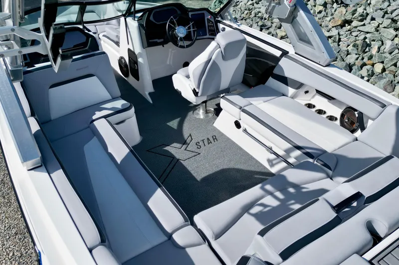Slide: The Image of 2022 MasterCraft XStar boat interior with sleek seating and modern dashboard design. - 7