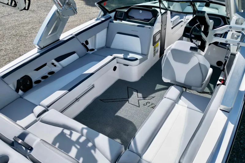 Slide: The Image of 2022 MasterCraft XStar boat interior with sleek seating and modern dashboard design. - 8