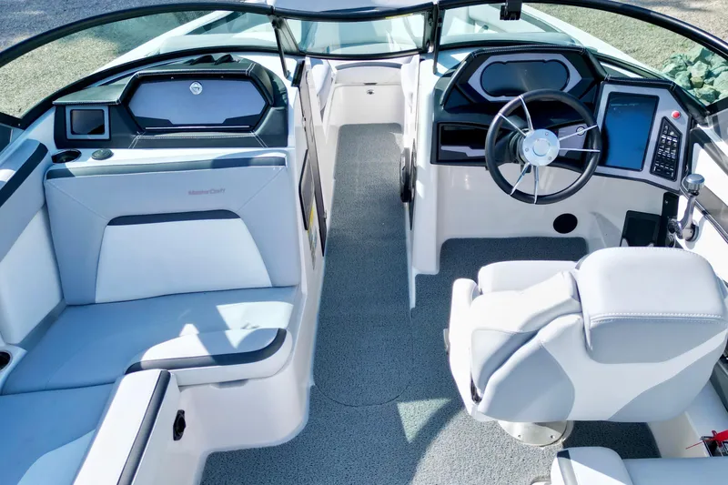 Slide: The Image of 2022 MasterCraft XStar boat interior with modern dashboard and seating. - 9