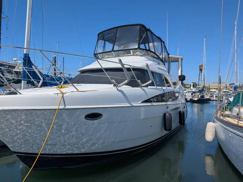 Slide: The Image of 2006 Meridian 368 yacht docked in a marina under clear blue skies. - 1