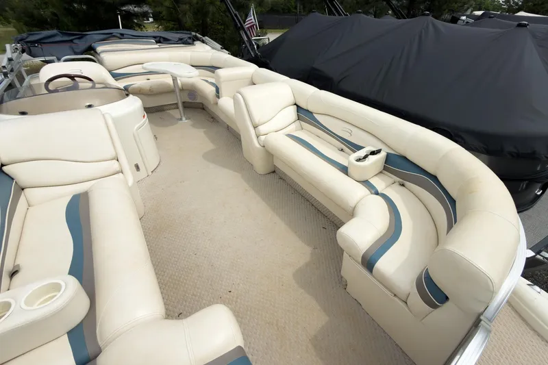 Slide: The Image of 2006 Bennington 2275RL pontoon boat with spacious seating and beige upholstery. - 2