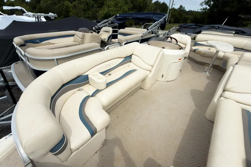 Slide: The Image of 2006 Bennington 2275RL pontoon boat with beige seating and spacious deck layout. - 3