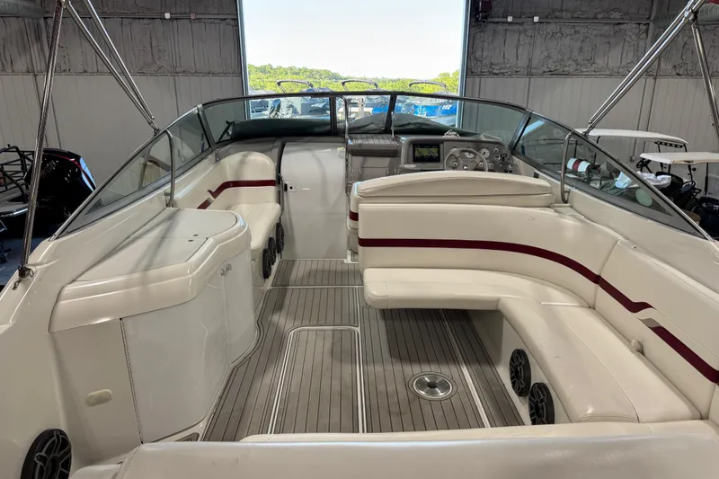 Slide: The Image of 2001 Formula 330 Sun Sport boat interior with white seating and red accents in a garage. - 10