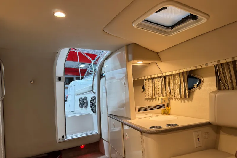 Slide: The Image of Interior of a 2001 Formula 330 Sun Sport boat, featuring a compact kitchenette. - 12