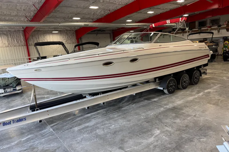 Slide: The Image of 2001 Formula 330 Sun Sport boat on trailer in indoor storage facility. - 3