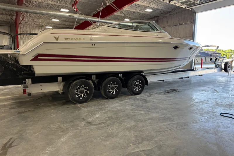 Slide: The Image of 2001 Formula 330 Sun Sport boat on trailer in indoor storage facility. - 4