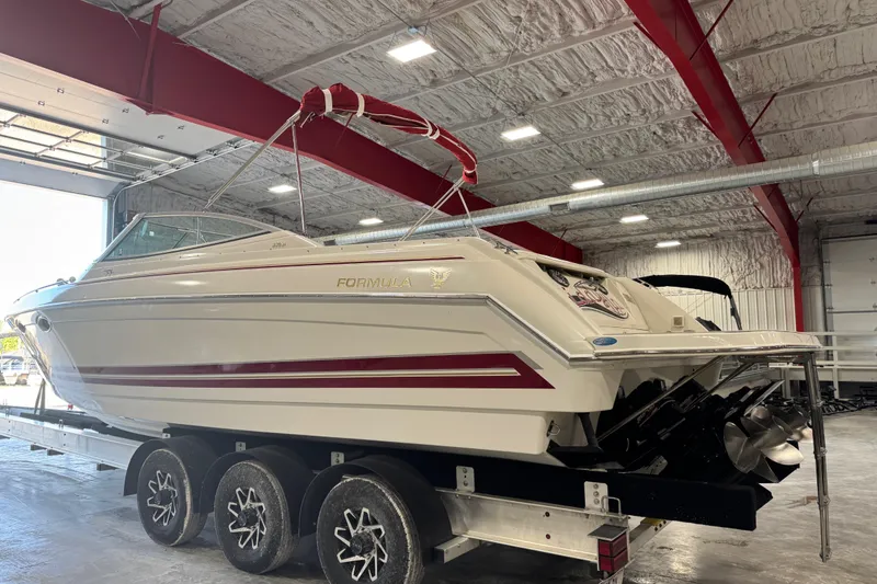 Slide: The Image of 2001 Formula 330 Sun Sport boat on trailer in indoor storage facility. - 5