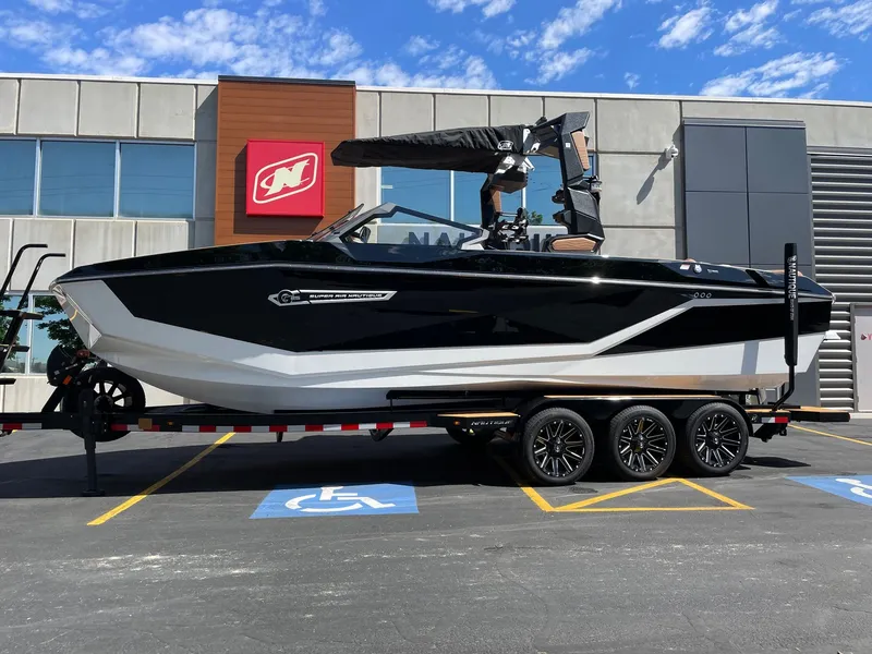 The Image of 2026 Nautique G25 boat parked in front of a modern building. - 1