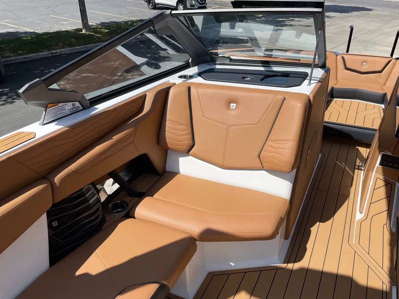 Slide: The Image of Interior of 2026 Nautique G25 with brown leather seating. - 10