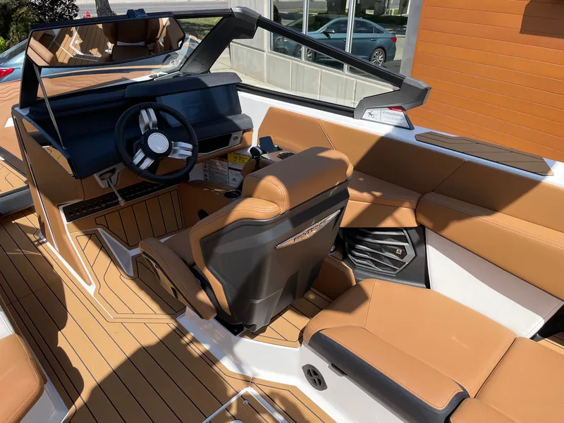 Slide: The Image of Interior of 2026 Nautique G25 with brown leather seats. - 6