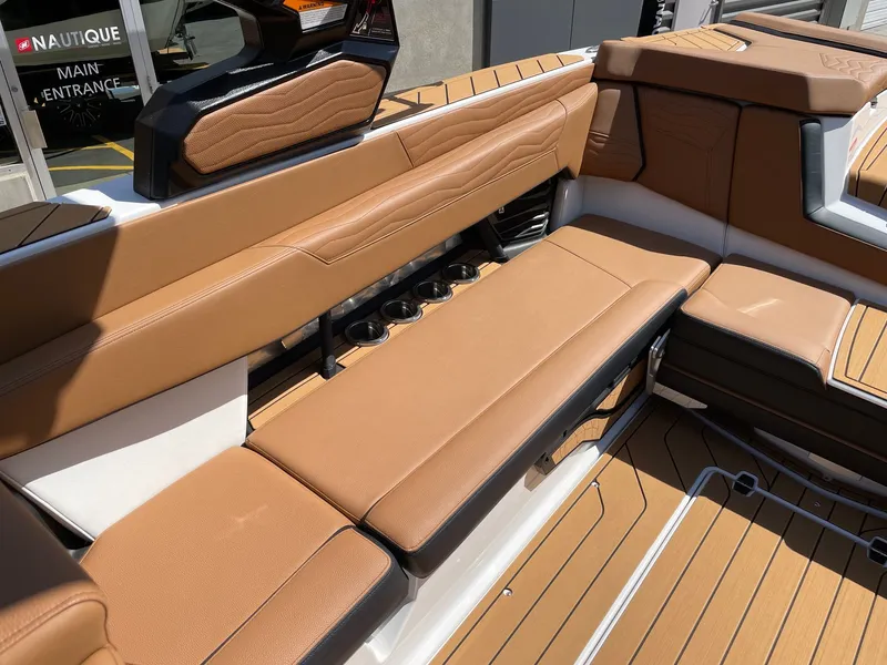 Slide: The Image of Interior of 2026 Nautique G25 with brown leather seating. - 7