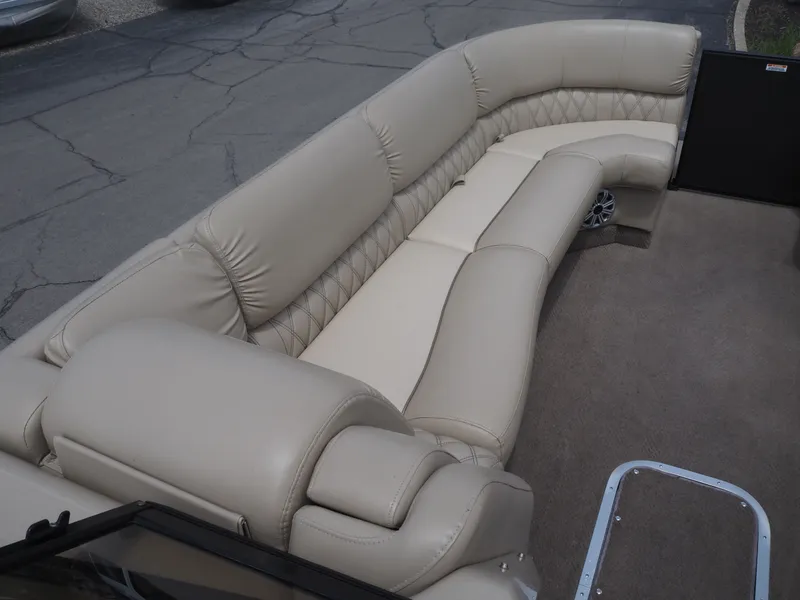 Slide: The Image of Interior of a 2015 Bennington 2572 RCW with beige leather seating. - 10