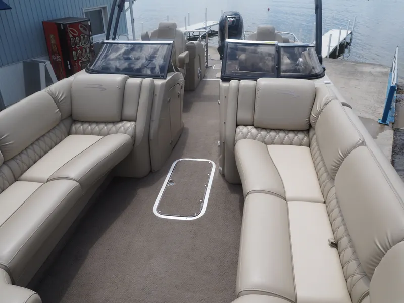 Slide: The Image of Interior of a 2015 Bennington 2572 RCW pontoon boat with beige leather seating. - 11