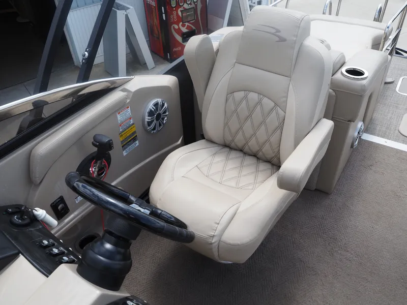 Slide: The Image of Interior of 2015 Bennington 2572 RCW with steering wheel and seat. - 13