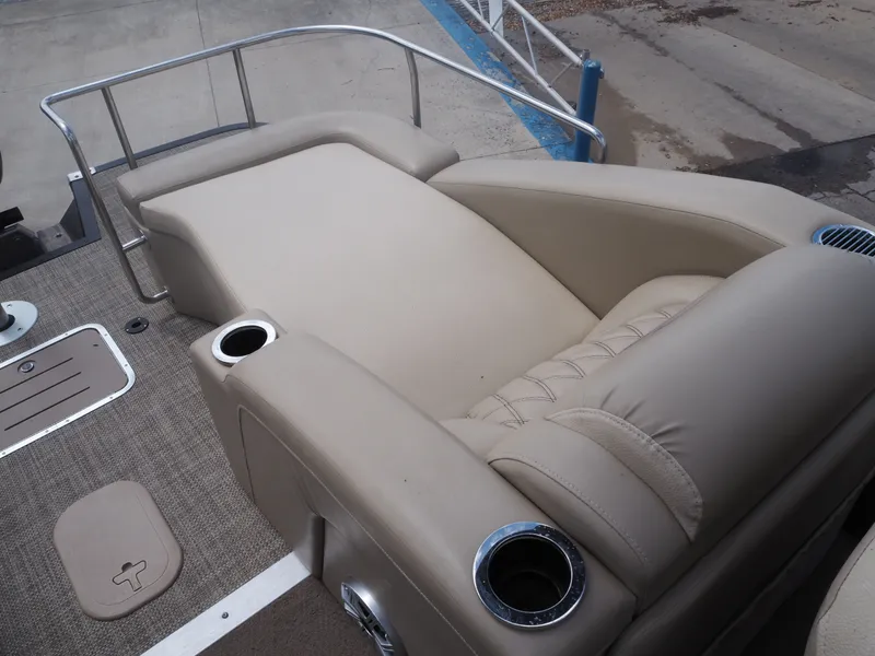 Slide: The Image of 2015 Bennington 2572 RCW boat with beige upholstered seating and cup holders. - 15