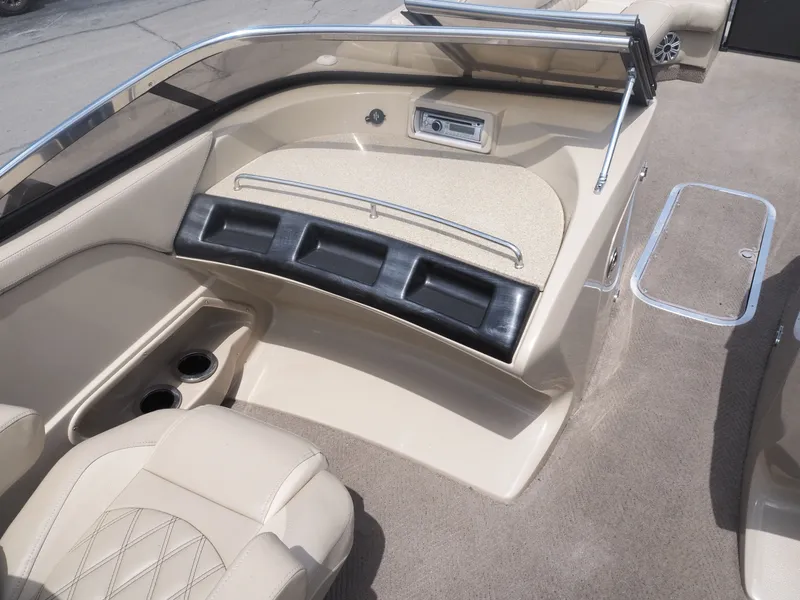 Slide: The Image of Interior of a 2015 Bennington 2572 RCW boat with beige seating. - 17