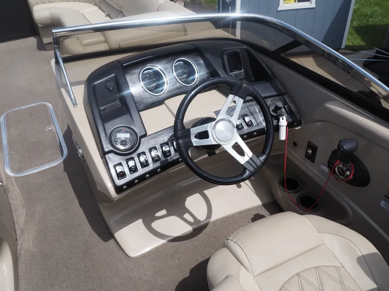 Slide: The Image of Interior of a 2015 Bennington 2572 RCW boat with steering console. - 18