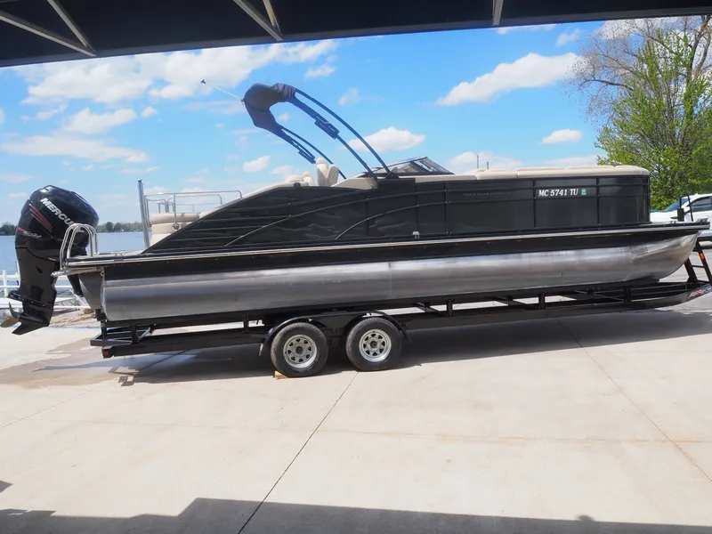 Slide: The Image of 2015 Bennington 2572 RCW pontoon boat on trailer by the lake. - 3