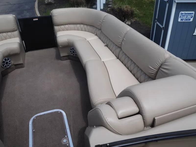 Slide: The Image of Interior of a 2015 Bennington 2572 RCW with beige leather seating. - 9