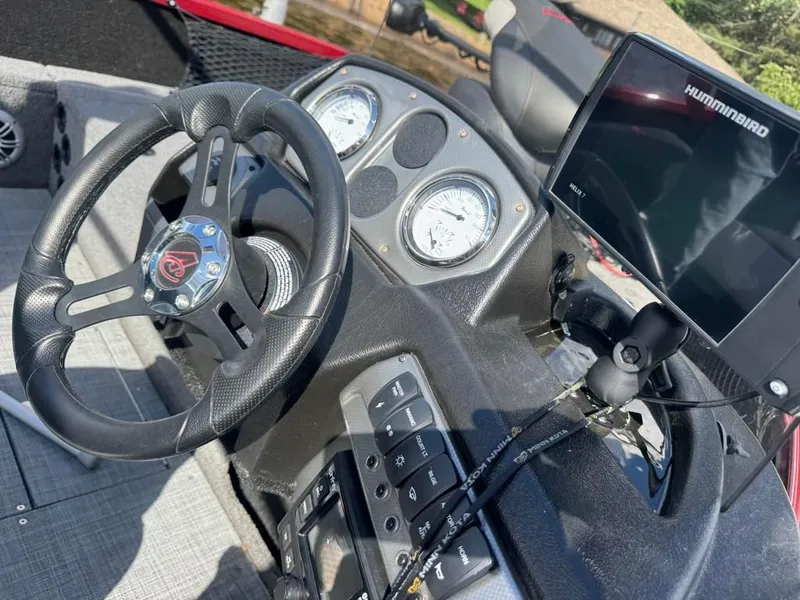 Slide: The Image of Dashboard of 2023 Alumacraft Competitor 165 CS with steering wheel and Humminbird display. - 16